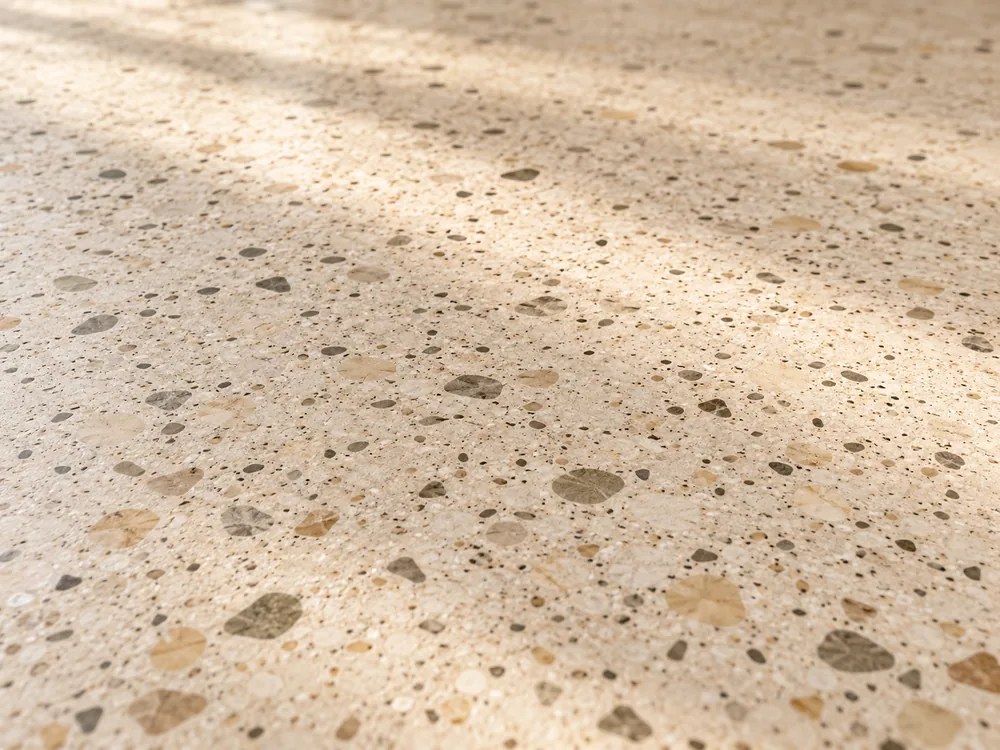 AI material study of ivory terrazzo and varied mineral fragments.